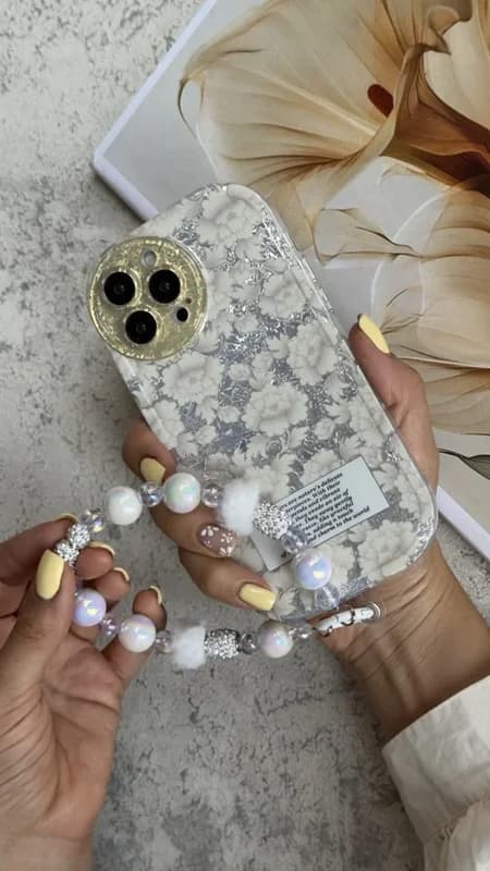 کاور آیفون گل مستر پیس سفید نقره ای + بندست مخملی